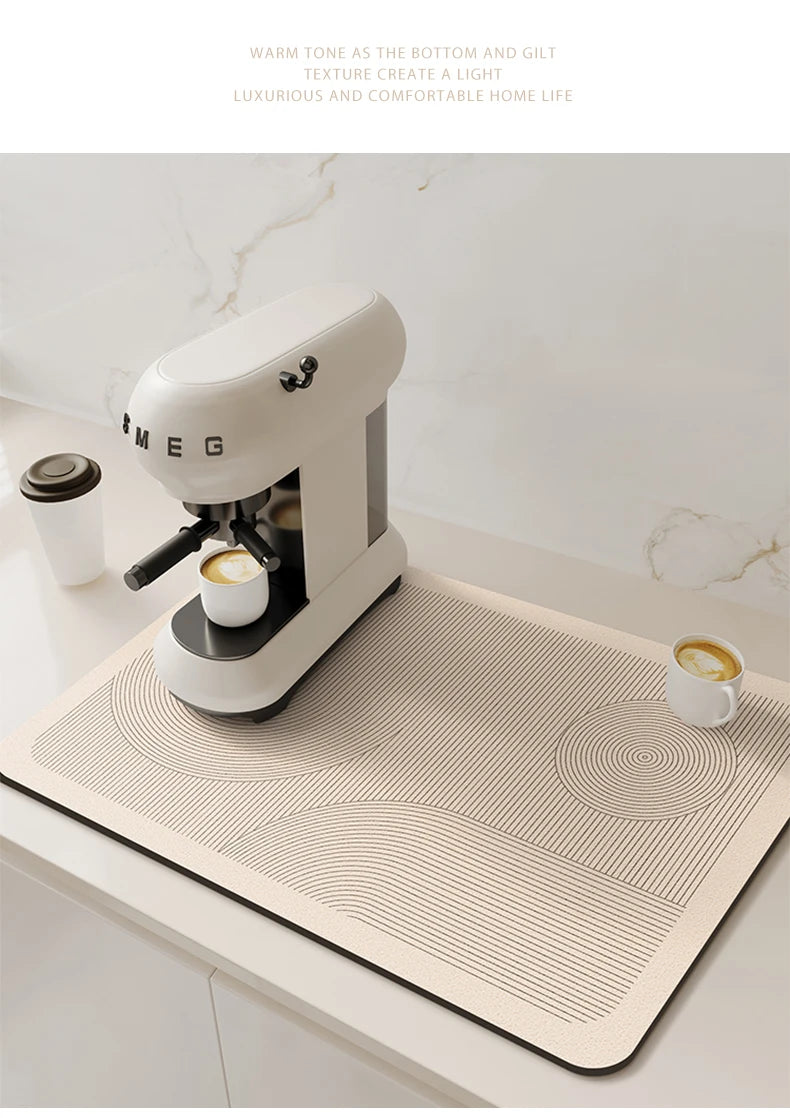 A white Meg coffee grinder sits on a beige quick-dry diatom mud absorbent counter mat.