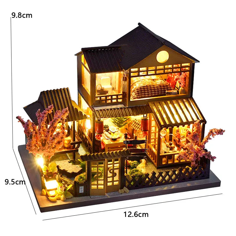 A detailed wooden miniature Japanese sakura tea house kit with LED lighting displayed on a base.