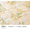 A close-up of a light beige fabric featuring an embroidered pattern of olive and sage green leaves on a quilted surface.