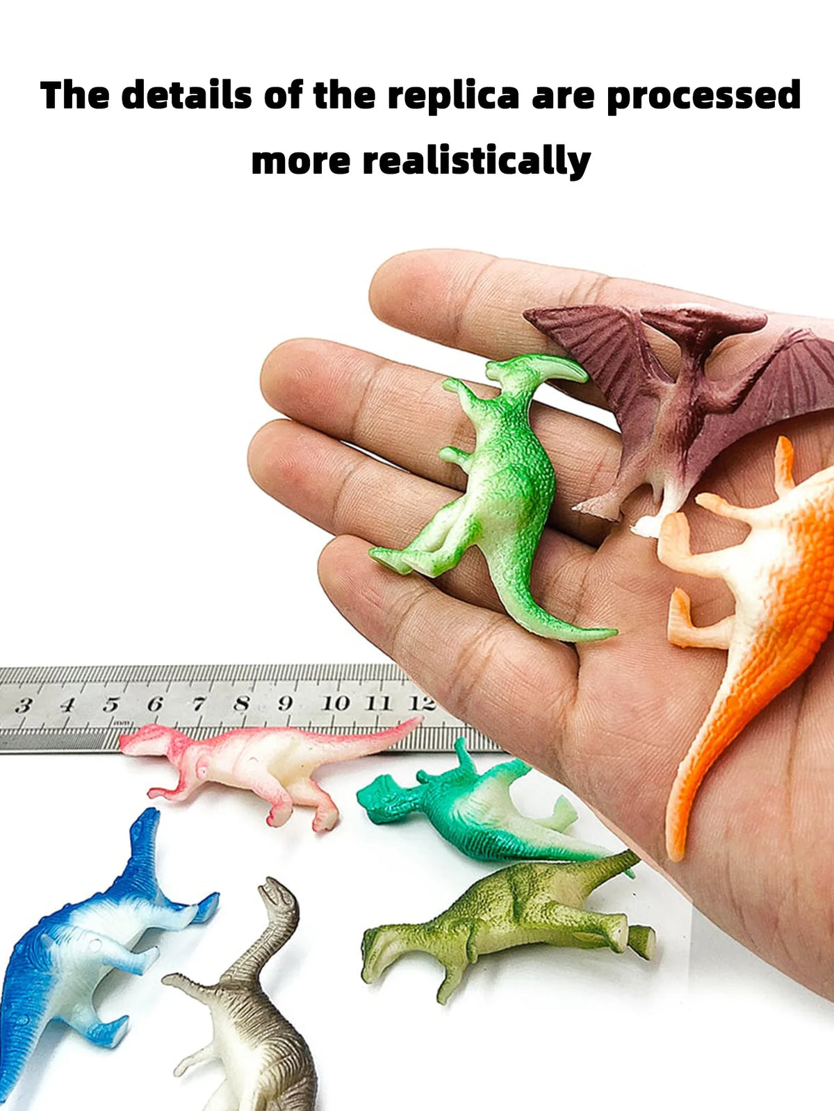 A hand holds a set of ten mini dinosaur figurines, including a green T-Rex and other species, displayed against a ruler.