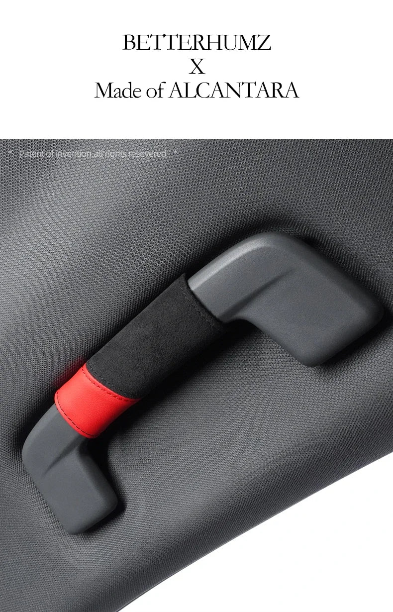 A close-up of a black grab handle protector cover with a red accent on a gray fabric surface.