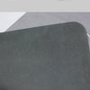 A close-up view of a dark gray natural diatomium mud floor mat.