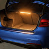 Rear view of a blue car showing an illuminated LED light inside the trunk.