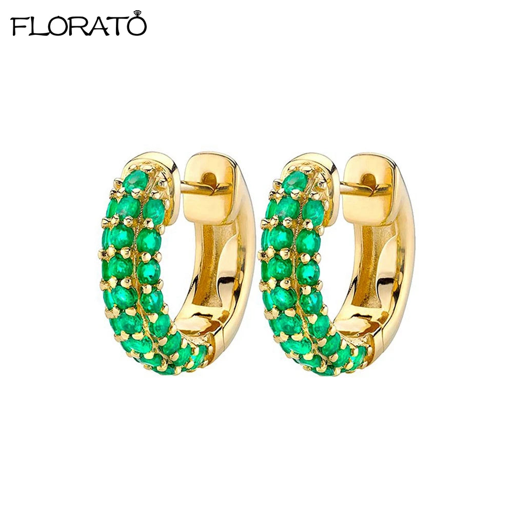 Gold huggie hoop earrings encrusted with green CZ stones