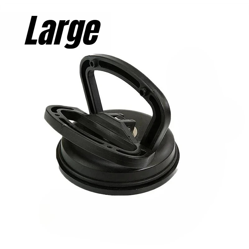 A black heavy-duty suction cup dent puller tool.