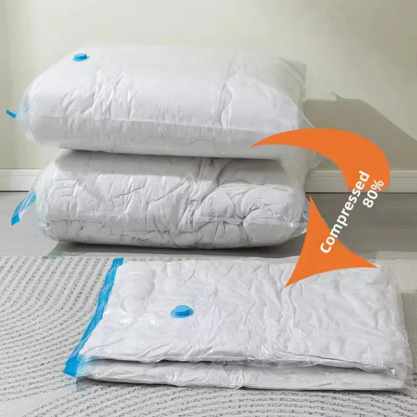 White vacuum storage bags with a hand pump stacked and laid out on a white surface.