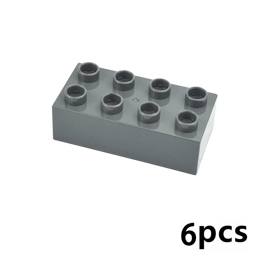 A gray plastic block set containing six round building blocks.