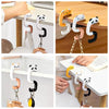 Various portable bag hooks in white, black, and yellow are shown attached to a desk or table surface.