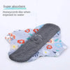 Reusable cotton menstrual pads with a floral pattern shown against a white background.