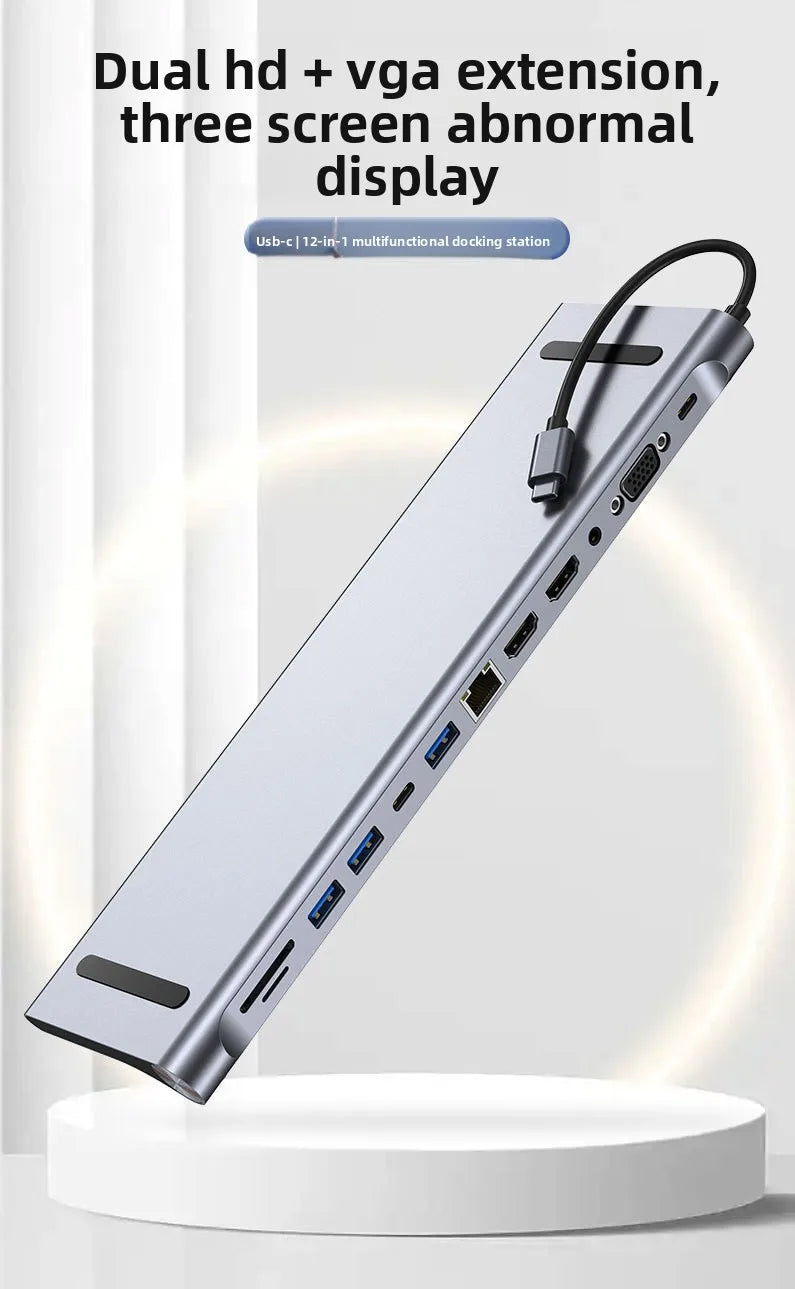 A silver 12-in-1 USB-C docking station with multiple ports and a cable is shown on a white stand.