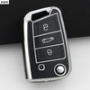 A close-up view of a silver car key cover with multiple buttons and a rotating mechanism.