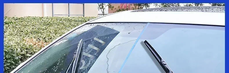 Close-up view of a white car's glass showing water beading, demonstrating hydrophobic rain repellent spray application.
