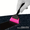 A hand is using a black installation tool with a pink blade to apply film onto a dark surface.