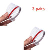 Two pairs of clear plastic rain and sun visors with red trim shown being held by a hand.
