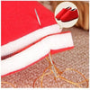 A red fabric case with white padding and sewing needles is shown next to a pair of red shoes.
