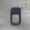 Black silicone protective case for a hand sanitizer spray attached to a gold keyring