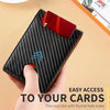 A black textured leather card holder with a thumb hole is shown being held, demonstrating easy access to cards.