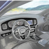 Interior view of a Dodge Charger showing carbon fiber trim and steering wheel for a custom kit.