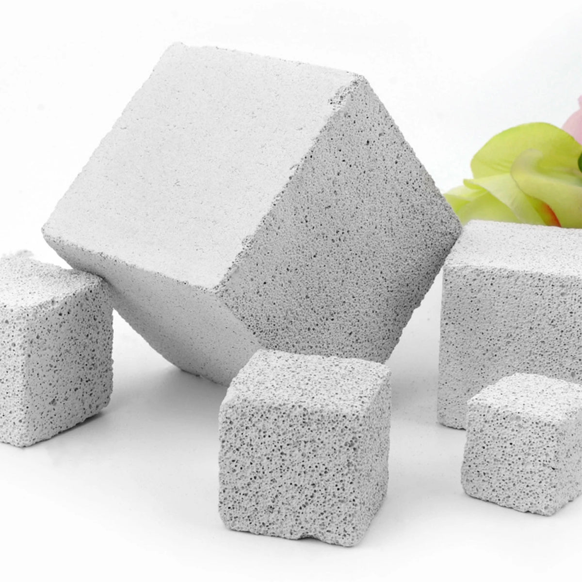 A pile of light gray natural mineral molar stones for small pets, shown from an angle.