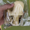 A beige playful animal toilet paper holder is shown inside clear plastic packaging.