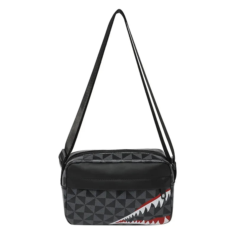 Black crossbody bag featuring a shark mouth graphic and adjustable strap.