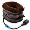 A stack of dark brown inflatable cervical traction neck stretchers with a black hose and nozzle.