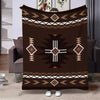 A dark brown flannel throw blanket featuring geometric ethnic patterns in white and tan.
