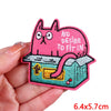 Pink cartoon cat embroidery patch with a distressed look and an iron-on backing