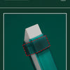 Close-up view of a teal cleaning eraser with an adjustable clamp design being used on a white faucet or sink surface.