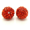 A pair of round, faceted, orange-red crystal clay beads for DIY jewelry and craft projects.
