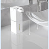 A white touchless infrared smart soap dispenser is shown on a bathroom counter next to a sink.