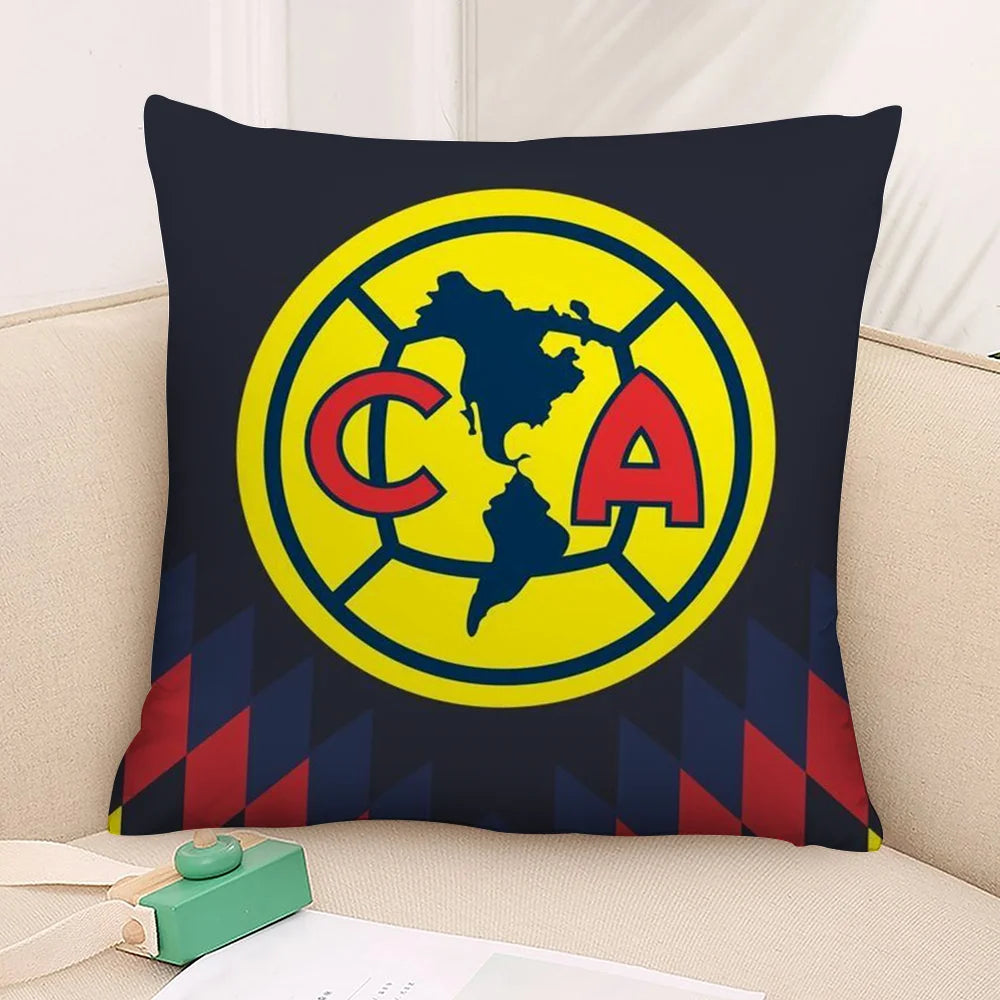A dark blue decorative pillow featuring a yellow circular logo with the letters CA inside.
