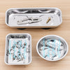 A silver magnetic parts tray with a strong magnet base, showing various hardware like screws and a key.