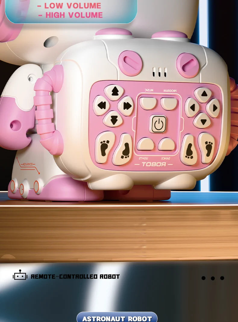 A pink interactive remote-controlled robot with large eyes and a control panel is shown on a wooden surface.