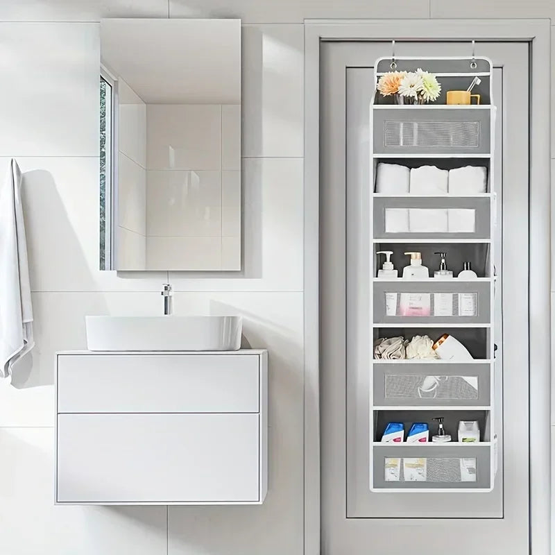 A gray 5-shelf over-the-door hanging storage organizer with various bathroom and personal care items.