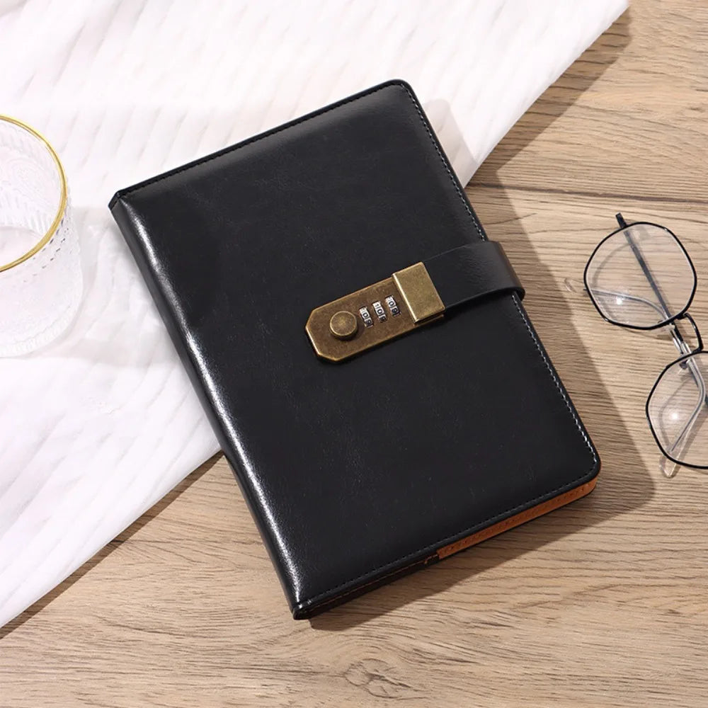 A black A5 password-locked diary with a leather strap and brass clasp resting on a wooden surface.