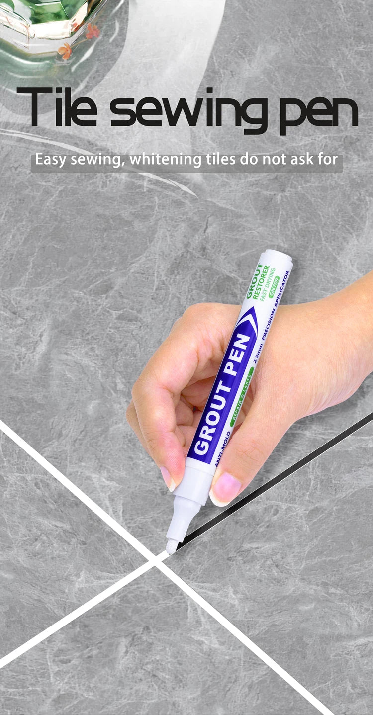 A hand holds a purple tile sewing pen applying grout to a gray tiled surface.