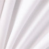 White fabric draped in soft folds, showing texture and light shadows.