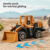 A yellow diecast construction vehicle tractor is shown gently pushing for inertial gliding on a sandy terrain.