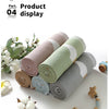 Rolls of soft cotton baby swaddle blankets in pastel colors with white cartoon prints displayed on a white surface.