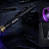 A compact professional-grade UV flashlight is shown illuminating a circuit board and a small object.