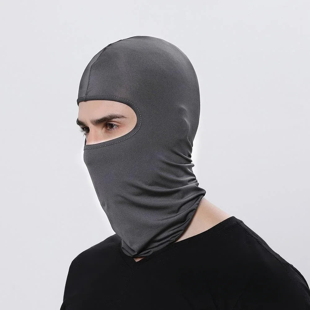 A man wearing a dark gray windproof full face balaclava.