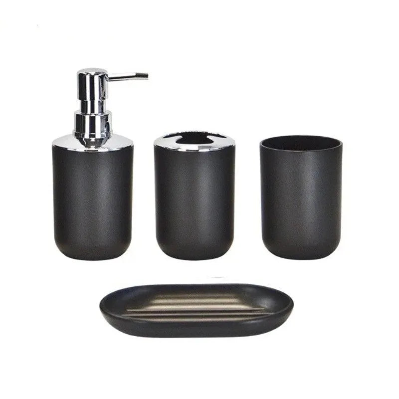A set of four black bathroom accessories including a soap dispenser, holder, and dish.