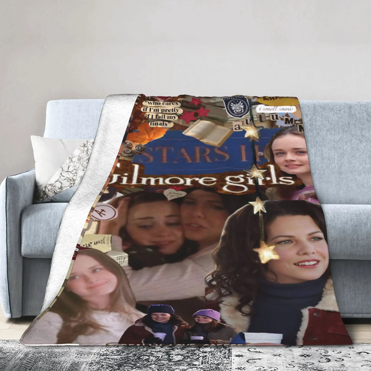 A throw blanket featuring a collage of Gilmore Girls characters and text on a gray sofa.