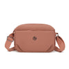 A light dusty rose nylon crossbody bag with a flap closure and leather strap.