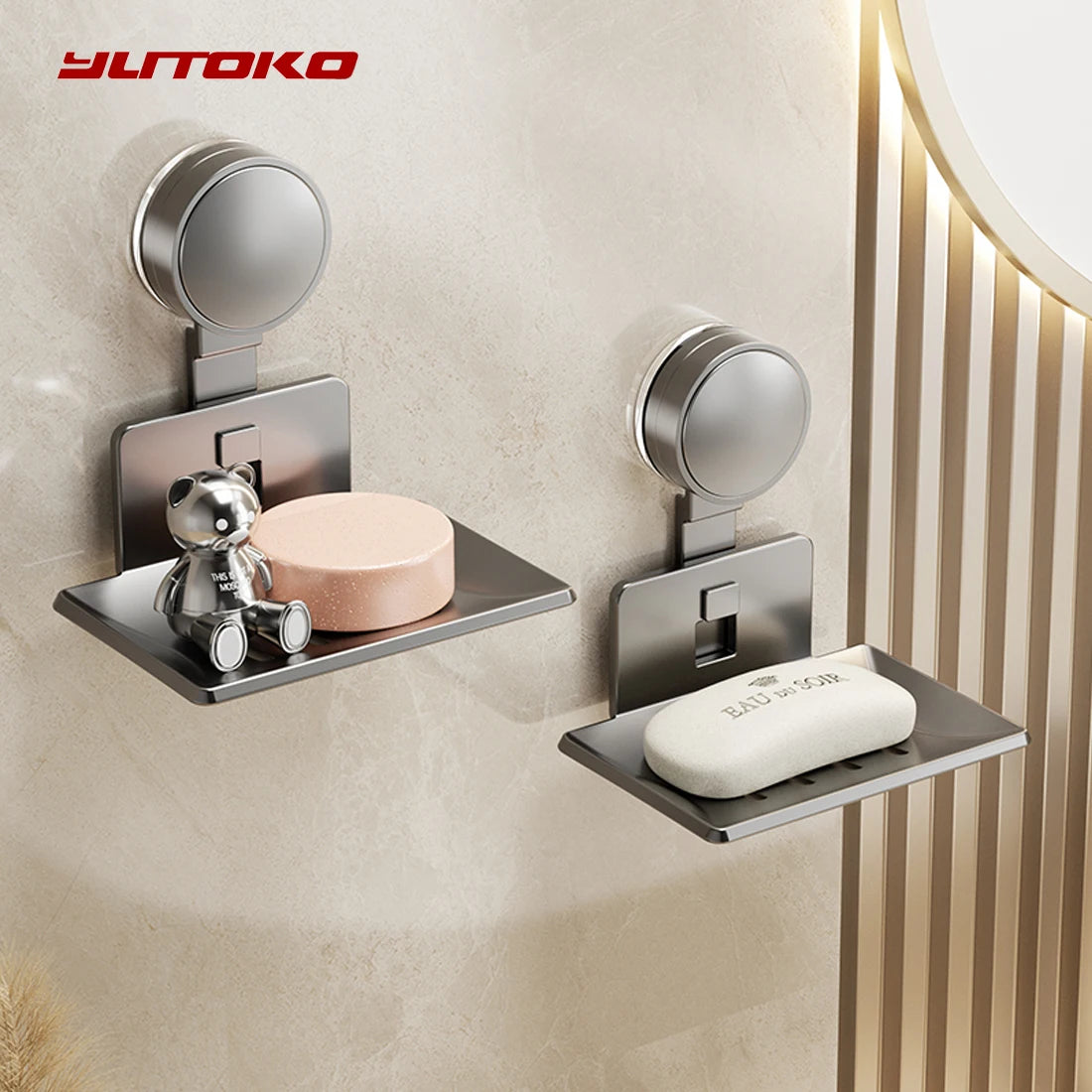 A silver wall-mounted soap dish with a suction cup holder and drain is installed on a beige wall.