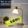 A yellow glow-in-the-dark silicone remote cover rests on a desk next to a lamp.