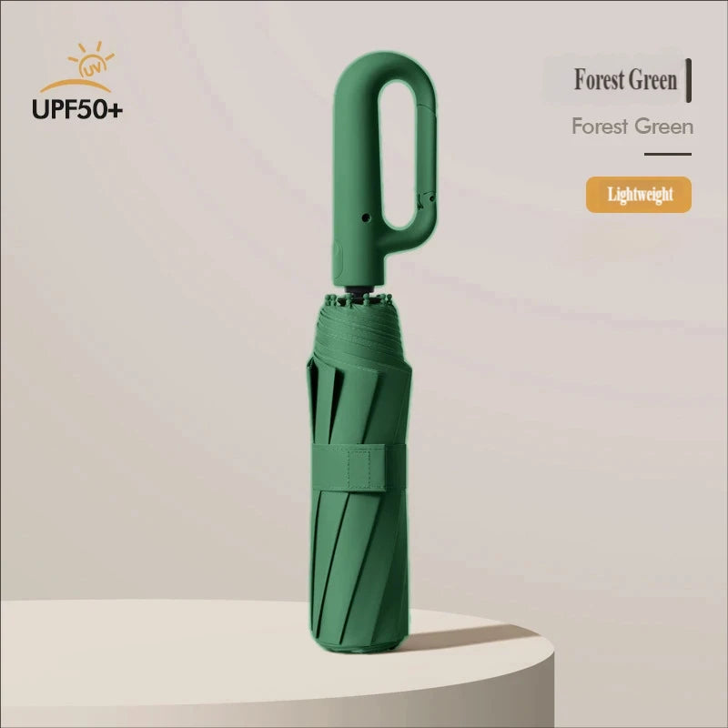 A forest green automatic folding umbrella with a lightweight design shown standing on a white surface.