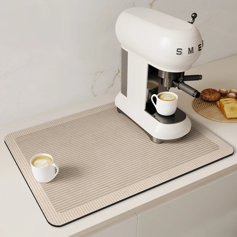 A white espresso machine is placed on a beige striped counter mat with a white cup of coffee and some toast.