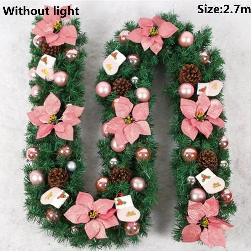 Green artificial Christmas garland shaped like the letter U, decorated with pink flowers and pearl ornaments.